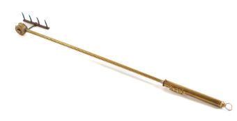 A brass 'Magic 318' patent revolving toasting fork: with metal tines.