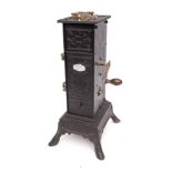 A 19th Century French clockwork spit engine: in blackened tin and metal casing,