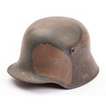 A WWI period German M1916 Stahlhelm:, hand painted camouflage finish with brown leather liner,