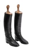 A pair of black officer riding boots with wooden trees.