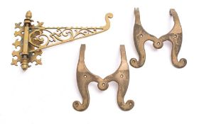 A late 19th/early 20th century brass adjustable wall bracket: the scroll decorated piecework arm