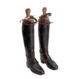 A pair of brown officer boots the type worn by officers in the household cavalry, with wooden trees.