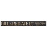 An early 20th century wooden tram advertising hoarding 'Gill & Reigate Ltd 25,