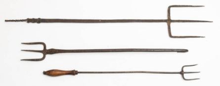 A group of three iron three prong forks: of various design: (3)