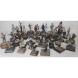 A collection of painted white metal and painted figures and vignettes in various scales from 1/35th