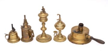 A brass hand held oil lamp: of bell shape, two other brass hand held lamps,