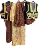 A late 20th century Chinese gold silk jacket: another black silk jacket, two wool waistcoats,