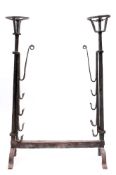 A 17th Century Continental wrought iron porte de cheminée: with twin circular cresset baskets on