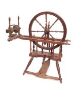 A 19th Century beechwood spinning wheel: with turned spindle spokes,