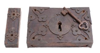 A 19th century oak and iron door lock: the key with trefoil bow,