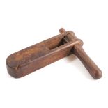 A 19th Century oak rattle: with turned handle.