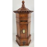 A wooden model of a replica Victorian hexagonal post box. With carved detail to top and turned