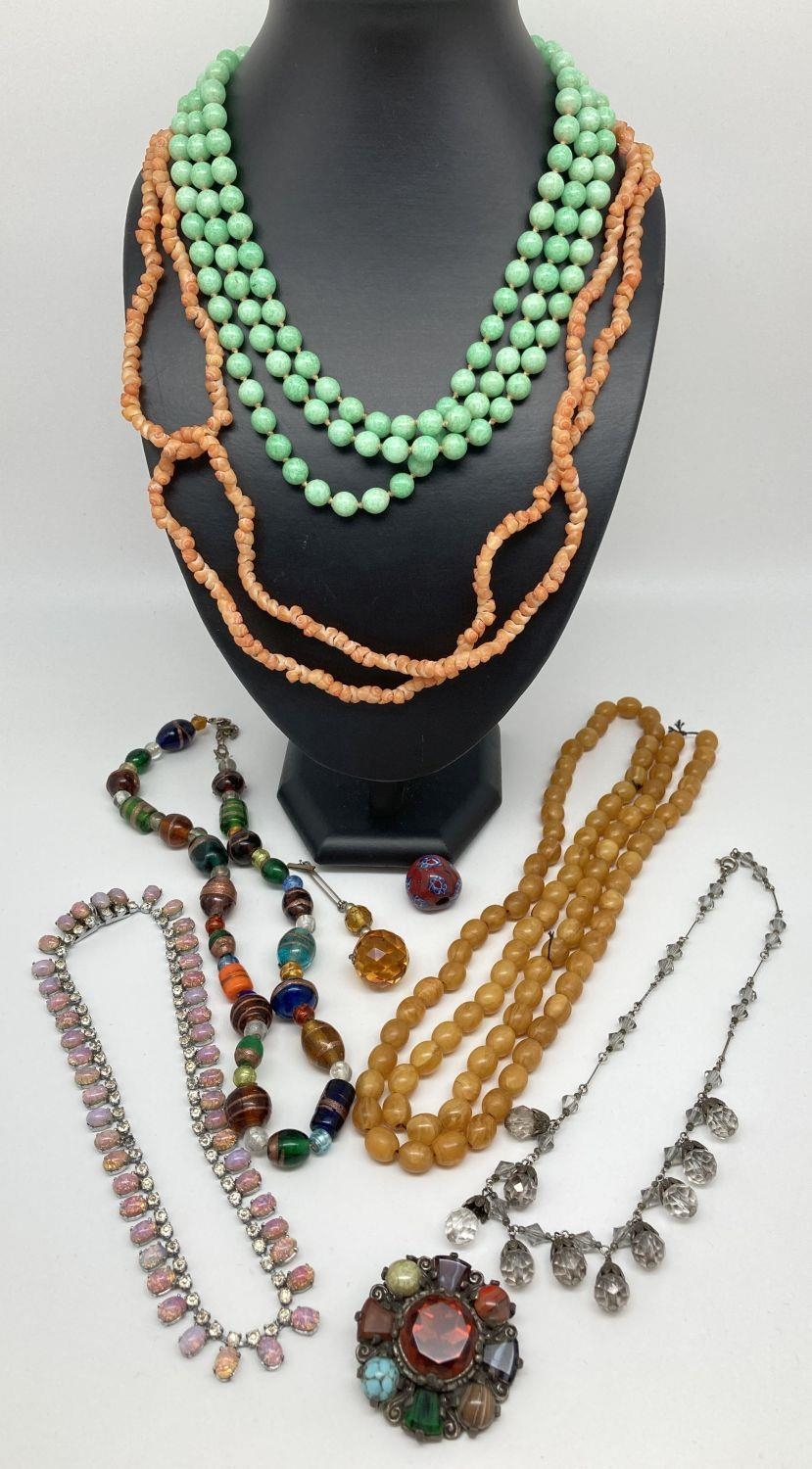 A collection of vintage costume jewellery. To include glass bead drop necklace, diamante and pink