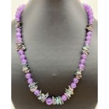 A very fine amethyst and fresh water peacock keshi pearl 20" necklace. With silver tone hook