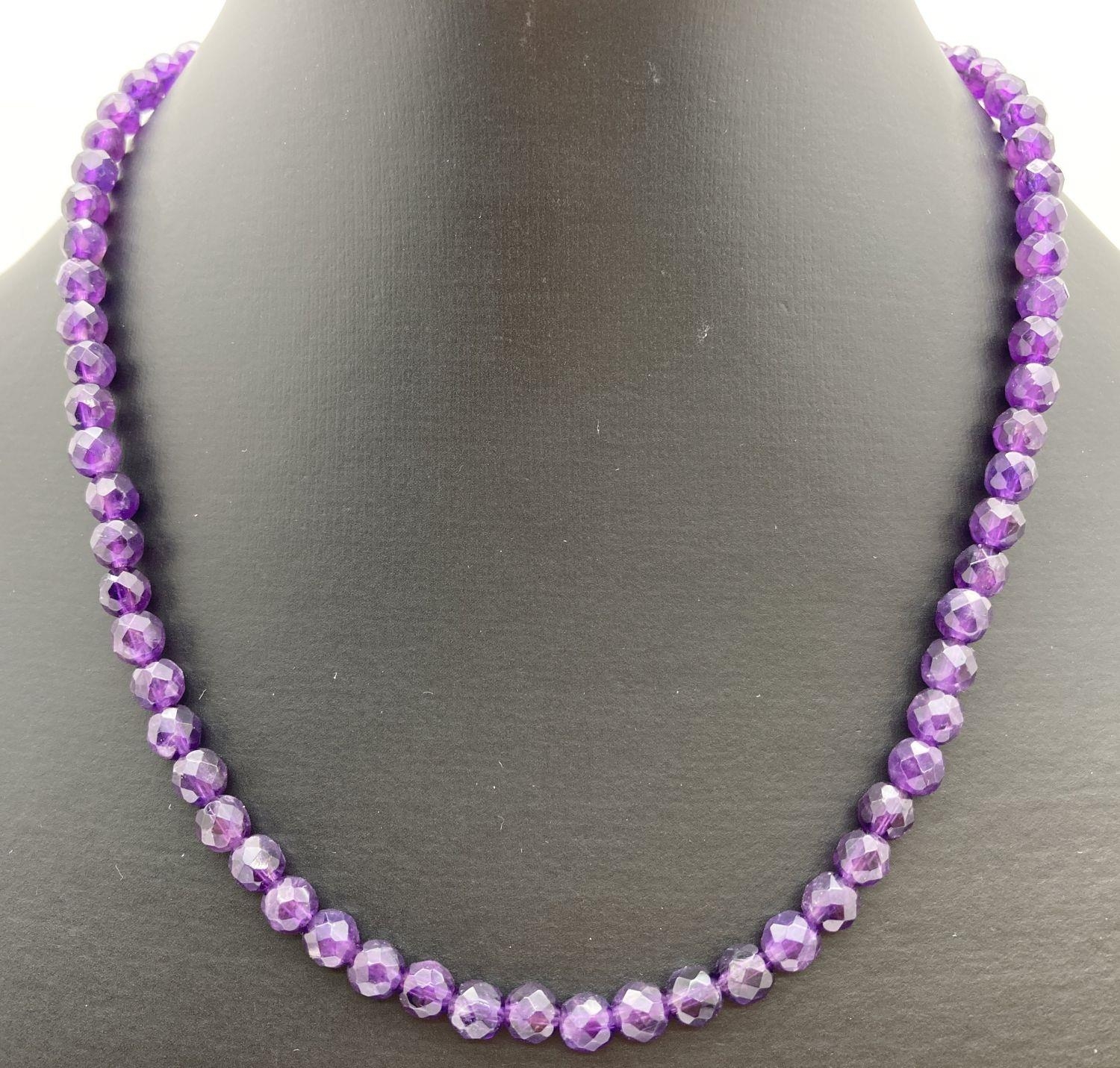 A 16" faceted amethyst beaded necklace with 9ct gold lobster claw clasp. Retired jewellery makers