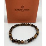 A brand new boxed natural tigers eye and stainless steel skull bead men's expanding bracelet.