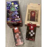 4 boxed Christmas decorations. A large silver light up bow, a snowflake projector, an LED light up