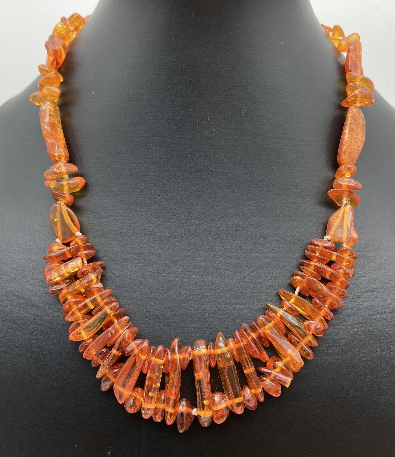 An 18" amber necklace made from varying sized pieces of amber, with screw barrel clasp.