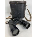 A pair of vintage binoculars with leather carry case and neck strap. Case marked "Bausch & Lomb".