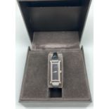 A boxed ladies 1500L silver tone stainless steel bracelet strap wristwatch by Gucci. Black face with