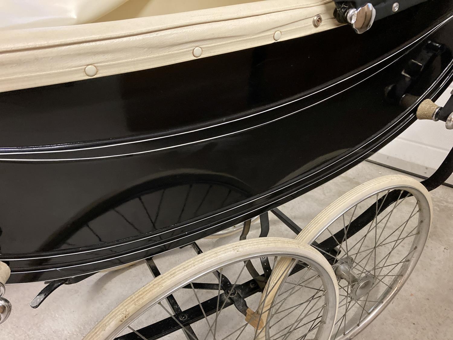 A vintage 1960's Sol Peram coach built pram painted in black & cream. Wooden bodied with cream - Image 10 of 12