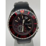 A men's 11182J wristwatch by Police with black leather strap. Black and red face. Luminous hand
