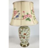 A large modern ceramic Chinese design table lamp with bird and cherry blossom detail. Raised on a