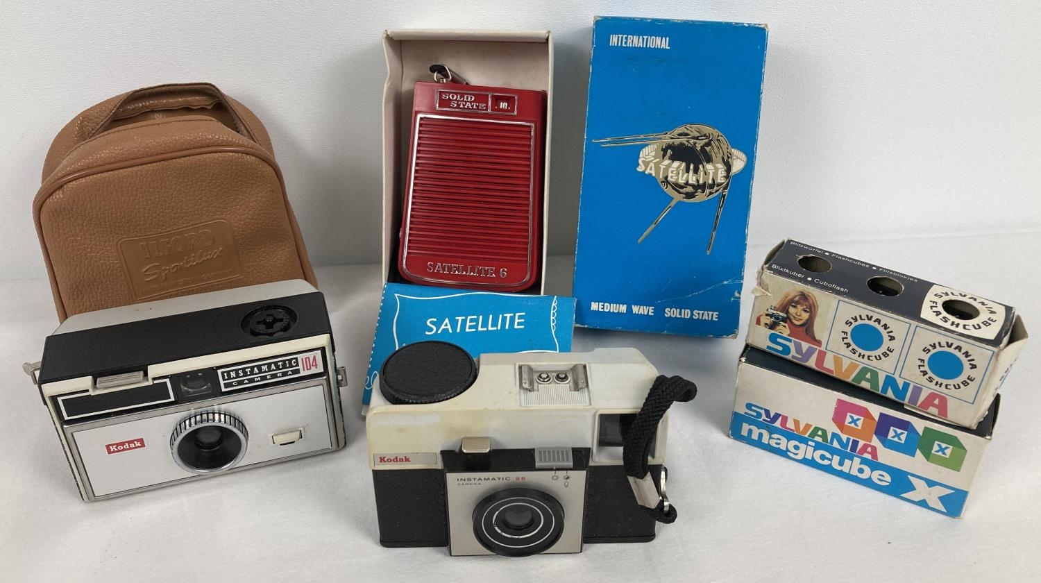 2 vintage Kodak cameras together with a boxed Solid State Satellite transistor radio. Model 010,