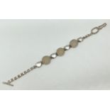 A modern design silver bracelet set with round cut druzy quartz and clear quartz cabochons. T bar