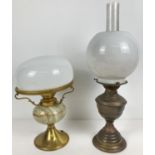 A vintage brass oil lamp with glass chimney and shade, together with a brass and green onyx desk