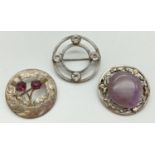 3 vintage silver, silver plate and white metal brooches, all in a circular design. A double circle