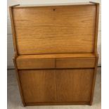 A vintage teak 2 drawer bureau by Remploy complete with key. 2 door cupboard base with interior