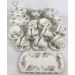 A collection of modern ceramic tea ware with a peach flower design. Comprising: 12 x cups & saucers,