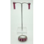 A double row eternity style silver dress ring set with 10 oval cut rubies and 29 small round cut