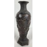 A Chinese bronze vase with dragon design and hexagonal shaped metal base. Impressed mark to