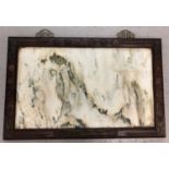 A large Oriental wall hanging stone panel in dark wood frame set with decorative brass plaques.