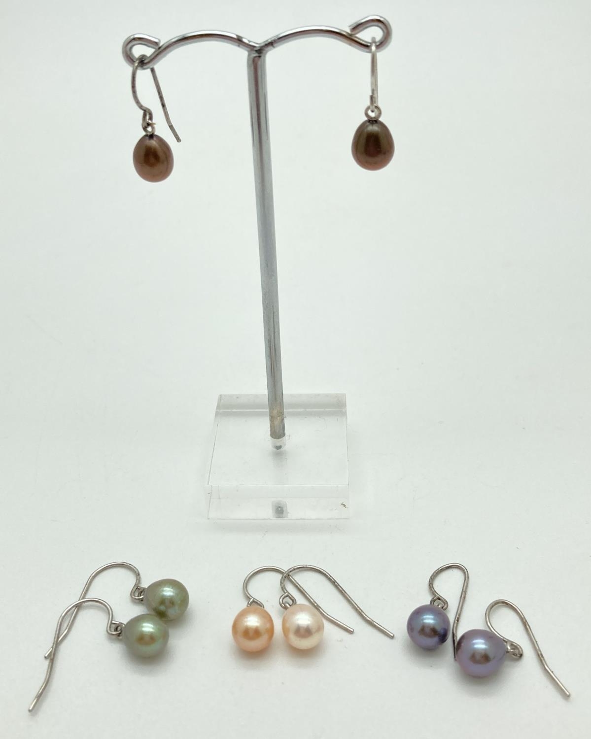 4 pair of coloured freshwater pearl and silver drop style earrings. Burgundy, gunmetal grey, peach