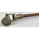 A reproduction wood and brass walking stick with swivel top telescope/compass handle. Approx. 95.5cm