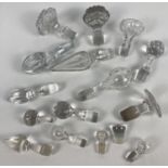 A collection of assorted clear glass bottle and decanter stoppers. In varying sizes.