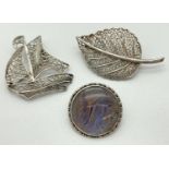 3 silver and white metal vintage brooches. A filigree leaf brooch, a filigree boat brooch and a