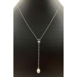 A modern design Singapore style chain necklace with long drop pendant. Set with a round cut clear