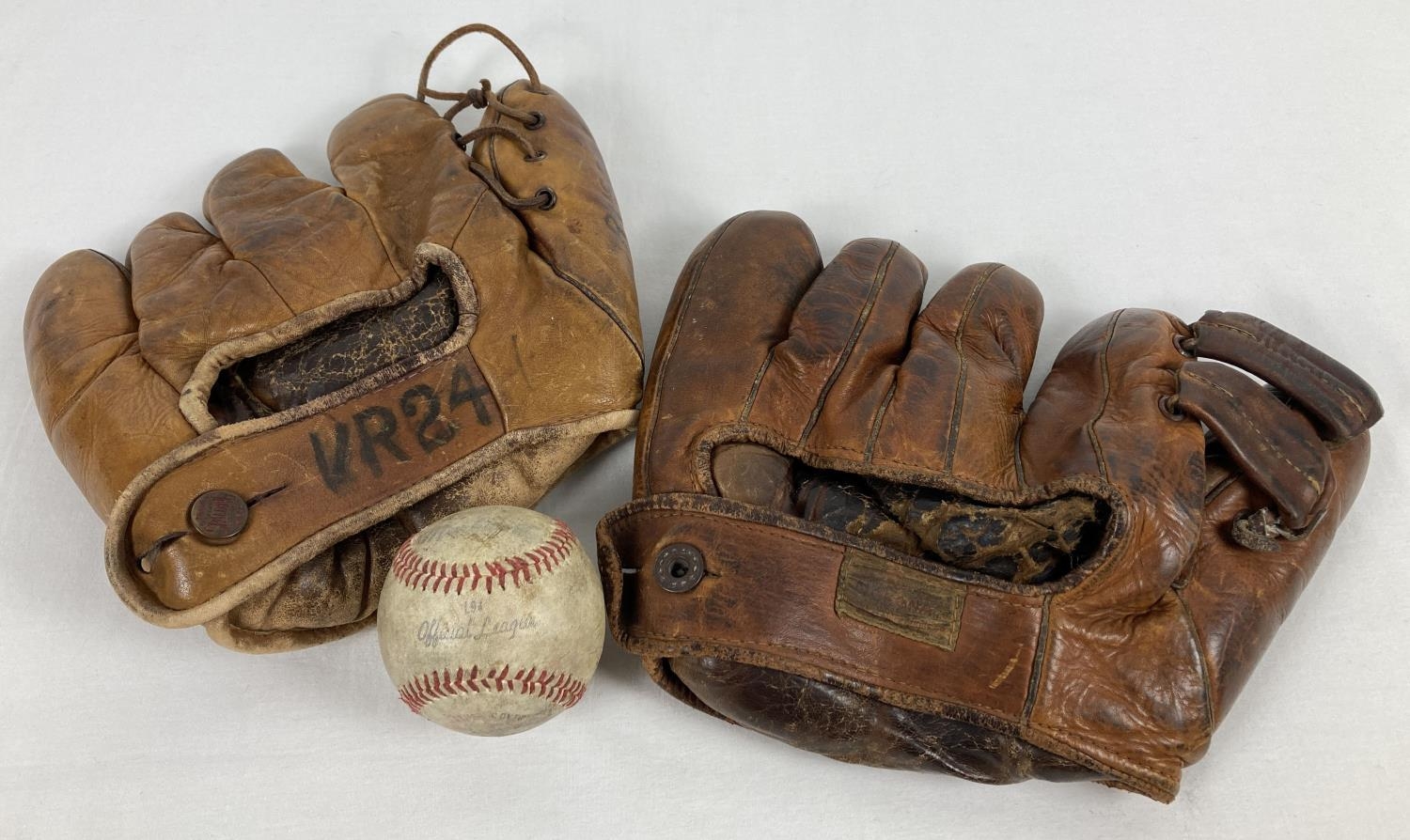 2 vintage leather baseball gloves, one marked "Softball USN" the other "Nokona". Together with a
