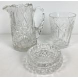 3 items of quality cut glass and crystal. A jug with shaped handle, a small vase and a decorative