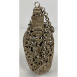 A Chinese white metal incense bottle with decorative pierced work panel front & back. Chained bottle