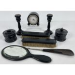 A vintage 9 piece ebony dressing table set. Comprising: a pair of candlesticks, clock, 2 x clothes