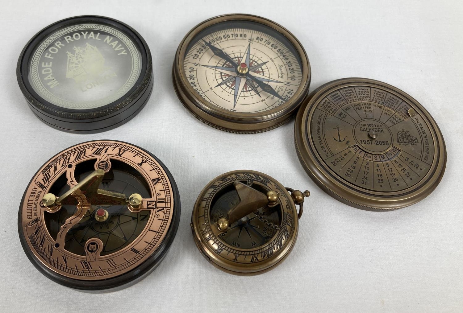 3 metal cased compasses. A large brass cased compass with screw top lid featuring a perpetual