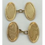 A pair of vintage 18ct gold chain link cufflinks with engine turned decoration. Oval shaped