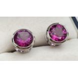A pair of modern 9ct white gold and hot pink sapphire earrings. Fully hallmarked to posts, with 'DK'