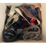 A large box of assorted mostly vintage belts to include leather examples.