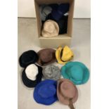 A box of assorted brimmed felt hats, in varying colours and styles.